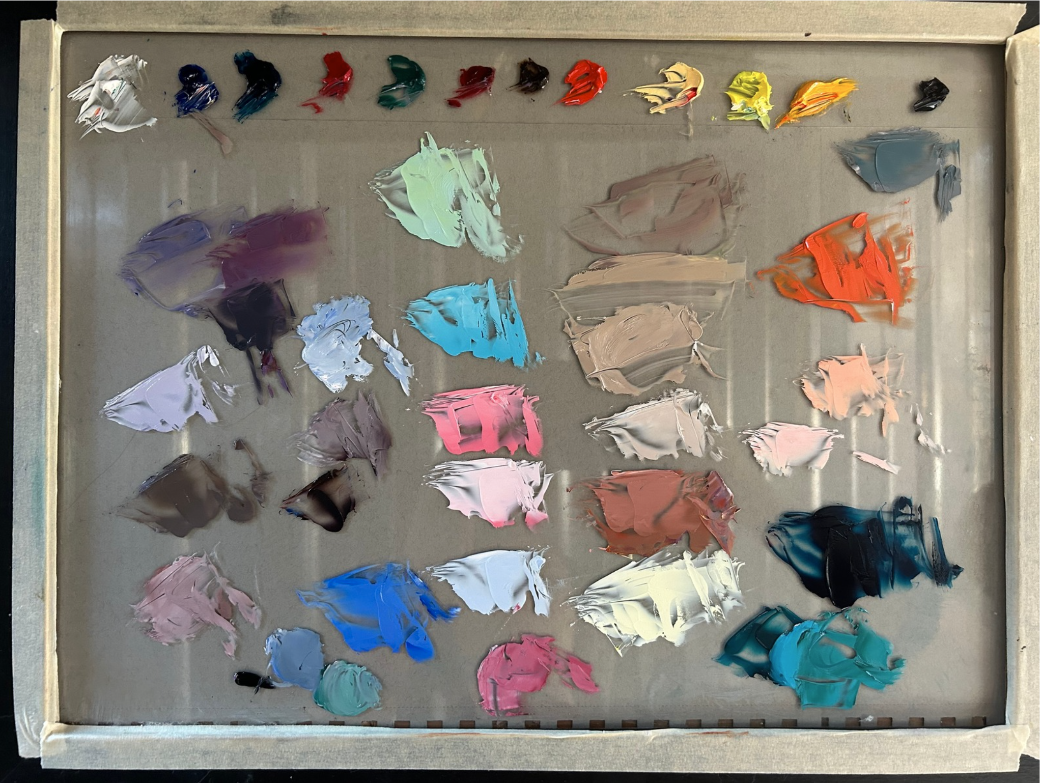Comparison of oil paint colors on a palette.